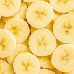 Fresh banana slices close up, tropical fruit background with soft yellow pulp, healthy food and...