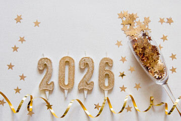 Happy new year frame. flat lay. top view. Christmas card banner with gold candle numbers 2026, glass and gold decorative ribbon, golden stars. Light background. Mockup