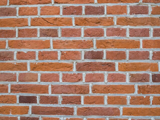 Red orange brick wall texture, rough masonry surface for construction and design background