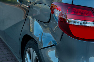Close up of car body after accident with visible scratches and dents, damaged vehicle exterior,...