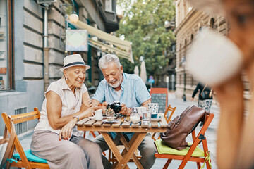 Happy seniors enjoying coffee together