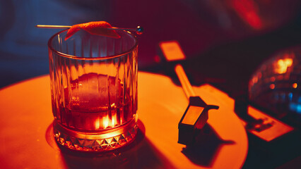 Elegant champagne coupe on vinyl record with purple background. Concept of celebration branding, entertainment lifestyle, social media content, and premium alcohol visuals.