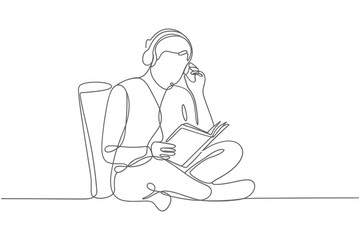 Person wearing headphones reading a book while sitting