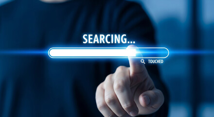 A finger touches a virtual loading bar on a screen with the word searching, representing data processing and progress