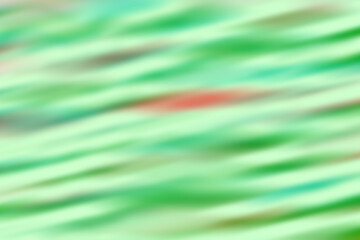 Abstract blurred background with green, red, and white diagonal lines pattern