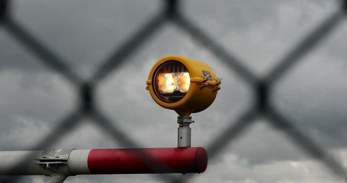 Airport runway precision approach path indicators lights in yellow metal casing. Close up, telephoto shot, shallow depth of field, no people