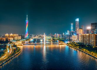 Fototapeta premium Modern financial district with skyscrapers and bridge over the river in Guangzhou.