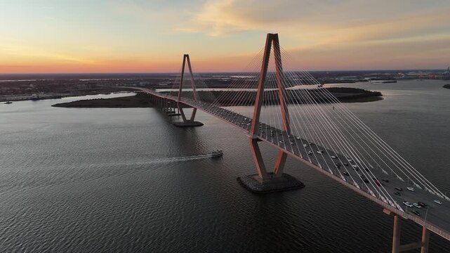 Arthur Ravenel Jr Bridge cars driving over Cooper River at sunset 4K aerial drone shot Charleston South Carolina