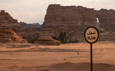 A slow down sign near Al Ula in the desert of Saudi Arabia