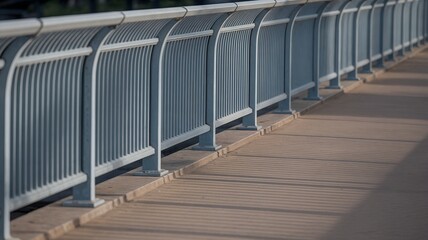 Wide crop of repeating bridge railing pattern with long afternoon shadows