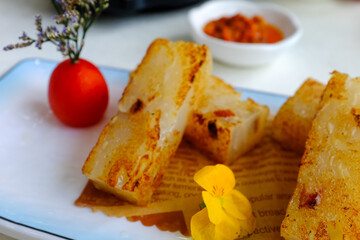 Turnip Cake on the table. Chinese Yum Cha scene. Traditional, common and popular food in Yum Cha culture. Chinese culture and Chinese cuisine. Food and beverage concept.
