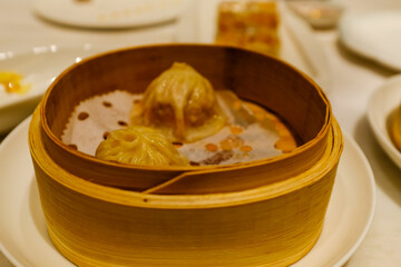 Close-up of the soup dumplings, xiaolongbao. Traditional, common and popular food in Yum Cha culture. Chinese culture and Chinese cuisine. Food and beverage concept.