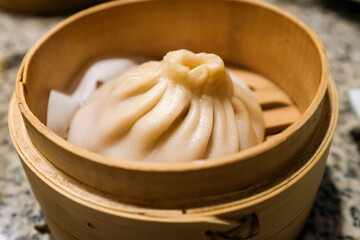 Close-up of the soup dumplings, xiaolongbao. Traditional, common and popular food in Yum Cha...
