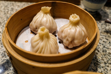 Close-up of the soup dumplings, xiaolongbao. Traditional, common and popular food in Yum Cha culture. Chinese culture and Chinese cuisine. Food and beverage concept.