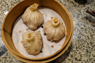 Close-up of the soup dumplings, xiaolongbao. Traditional, common and popular food in Yum Cha culture. Chinese culture and Chinese cuisine. Food and beverage concept.