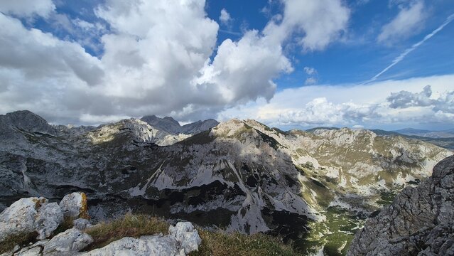 Majestic rocky summit enveloped by bold, sweeping clouds. A raw and powerful image that captures the spirit of high-altitude adventure and rugged wilderness.