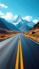 Sun-drenched asphalt ribbon unwinds towards distant, snow-capped peaks Azure sky above , majestic, steep, winter