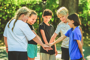 teens in sportswear playing basketball game outside together
