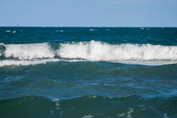 Foamy sea waves crash in layers beneath a clear sky, capturing the restless beauty of the open sea in Bulgaria