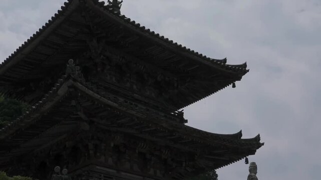 The three-storied pagoda near Takatori Castle (Japan's Top 100 Castles) has overhanging eaves, dougong of traditional wooden Buddhist architecture and a huge Guanyin stone statue in the distance.