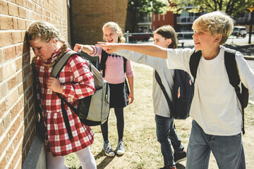 sad girl Bullying in Schoolyard with other student have some intimidation attitude