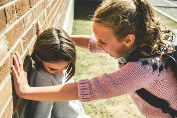 sad moment Elementary Age Bullying in Schoolyard