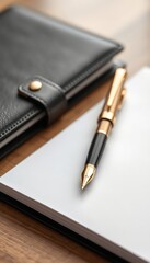 Notebook and elegant pen poised on a wooden surface, ready for notes or creative writing