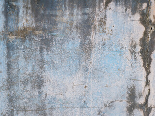 Weathered blue concrete wall with grunge texture, peeling paint, and stains, perfect for...