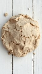 Light brown meringues on a white wooden surface, providing a textured top-down view for culinary or baking themed content