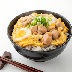 Oyakodon Japanese Chicken and Egg Rice Bowl Topped with Scallions on White Background