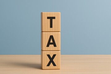 Wooden blocks stacked with the word tax against a light blue background minimal style