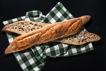 Crusty Baguette Slices On Dark Background with Cloth Fresh Bakery Sourdough Bread Close-Up For Food Photography