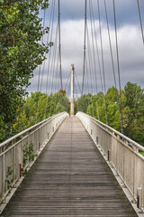 Scenic vertical view of Michel Serres footbridge across Garonne river, Agen, Lot-et-Garonne, France