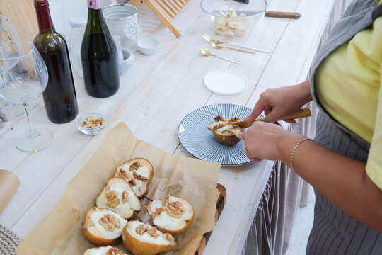 woman baking pears with ricotta and walnuts - Powered by Adobe