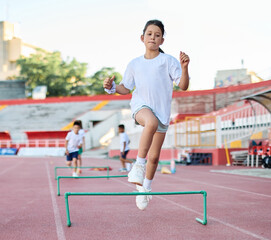 Fototapeta premium Portait of sports coach, children at stadium having althletics training. Portrait of athlete group, coaching and training at sport academy