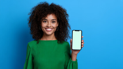 Smiling woman holding smartphone on blue background
