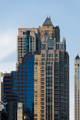 Close-up shot of various skyscrapers reaching up towards a clear blue sky in Chicago, Illinois.