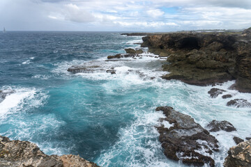 Animal Flower Cave and cliffs at North Point, St. Lucy, Barbados. Cave and cliffs with a coral floor that opens directly into Atlantic Ocean. Waves beating into the rock. 