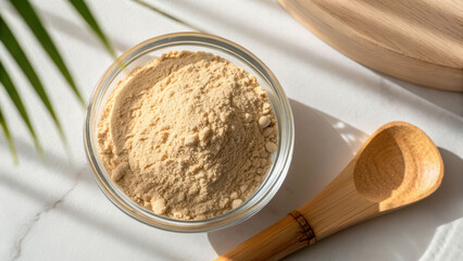 Adaptogen powder natural supplement in glass bowl on white table with wooden spoon and warm sunlight mood