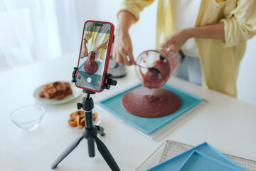 Middle aged woman preparing homemade fruit leather, slicing fresh fruit in her kitchen for healthy snack. Part of a series on organic treats and natural living. User-generated content. Live streaming