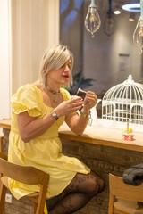Portrait of person posing in a public setting in yellow dress, eating ice cream, expressing confidence, identity, and self-acceptance. Gender expression of trance people in public. Crossdressing