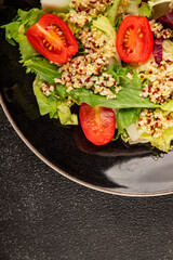 Quinoa salad tomato, green leaf salad vegetables dish natural tasty snack fresh delicious gourmet food background on the table rustic top view copy space keto and paleo diet vegan and vegan food