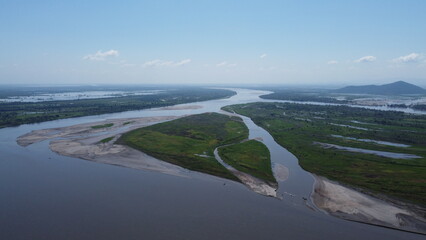 Aerial drone view river lake in middle trees blue sky near to sea, Cienaga, Colombia
