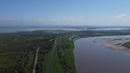 Aerial drone view river lake in middle trees blue sky near to sea, Cienaga, Colombia