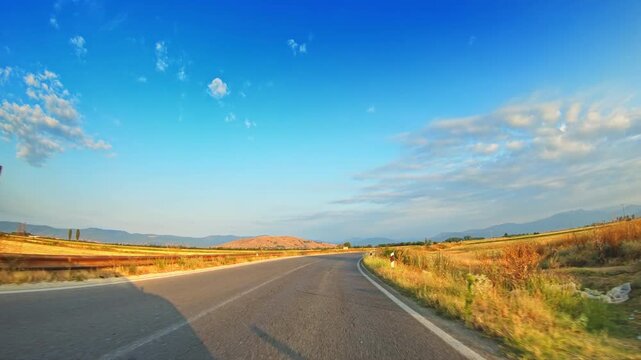 POV vehicle driving, rural scenery, cultivated fields, skyline