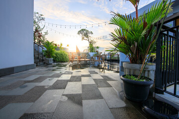 Patio with a black and white tile floor and a potted plant