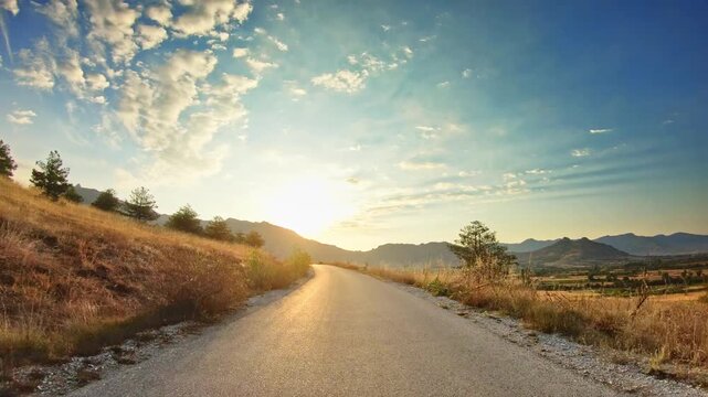 Golden hour, beautiful countryside, fields, dramatic sky, POV car drive