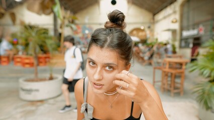 A woman enjoying her time in an urban cafe that features a beautiful natural aesthetic