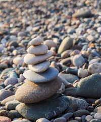 Cairn made of pebbles on the sea shore. Concept