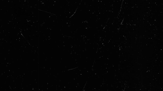 Dark textured background with scattered white specks and lines
